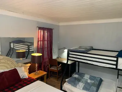 a bedroom with two bunk beds and a desk at Marmora and Lake Inn Apartment-Sleeps 5 guests in Marmora