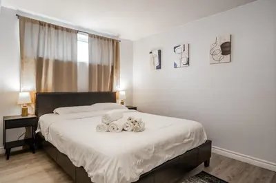 a bedroom with a bed with two stuffed animals on it at Modern & Spacious 2BR 2BA Suite All Amenities Included in Brampton