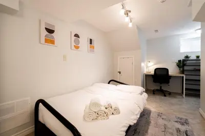a bedroom with a bed with towels on it at Modern & Spacious 2BR 2BA Suite All Amenities Included in Brampton