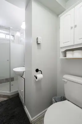 a white bathroom with a toilet and a sink at Modern & Spacious 2BR 2BA Suite All Amenities Included in Brampton