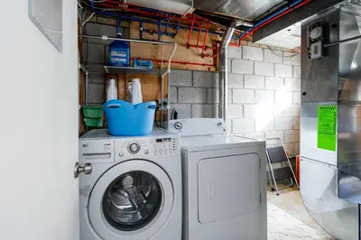 a laundry room with a washing machine and a washer at Modern & Spacious 2BR 2BA Suite All Amenities Included in Brampton