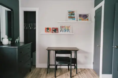 a dining room with a table and a chair at Sandbanks Cottage on Sheba's Island - 5 min drive, pet friendly in West Lake
