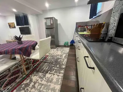 a kitchen with a sink and a table and a counter at cozy private guest suite in Richmond Hill