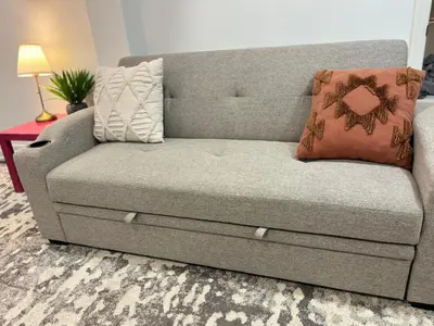 a couch with two pillows on it in a living room at cozy private guest suite in Richmond Hill