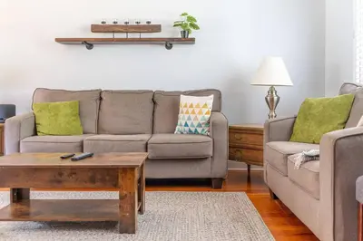 a living room with a couch and a coffee table at Golden Field Farmhouse - stayinpec on IG in Bloomfield