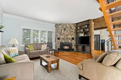a living room with two couches and a fireplace at Golden Field Farmhouse - stayinpec on IG in Bloomfield