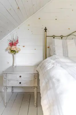 a bedroom with a bed and a vase of flowers on a table at Golden Field Farmhouse - stayinpec on IG in Bloomfield