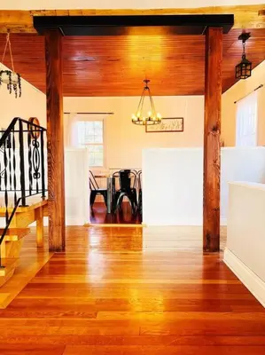 a living room with wooden floors and a dining room at Golden Field Farmhouse - stayinpec on IG in Bloomfield