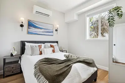 a white bedroom with a bed with a blanket on it at The Garden Suite in London, On 1BR, 1B with free washer and dryer in London