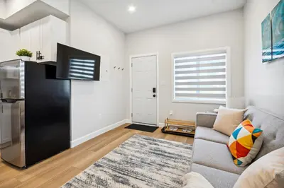 a living room with a couch and a flat screen tv at The Garden Suite in London, On 1BR, 1B with free washer and dryer in London