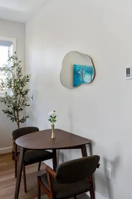 a dining room table with two chairs and a mirror at The Garden Suite in London, On 1BR, 1B with free washer and dryer in London