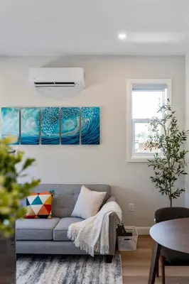 a living room with a couch and paintings on the wall at The Garden Suite in London, On 1BR, 1B with free washer and dryer in London