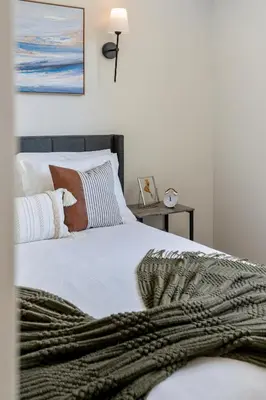 a bedroom with a bed with a blanket on it at The Garden Suite in London, On 1BR, 1B with free washer and dryer in London