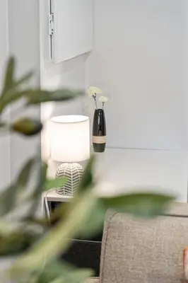 a lamp sitting on a table next to a couch at Haven Suite in London, On 2Br, 1Bath with free washer and dryer in London
