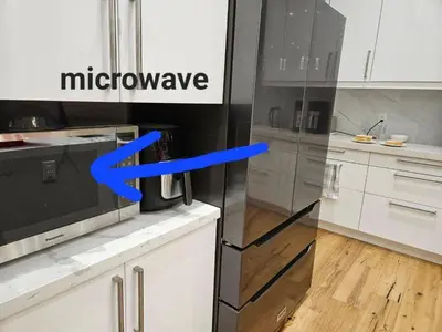 a kitchen with a refrigerator with a blue arrow at Comfortable Room in Toronto next to Yorkdale mall in Toronto
