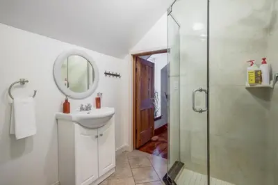 a white bathroom with a sink and a shower at The Marigold PEC Family Farmhouse country escape in West Lake