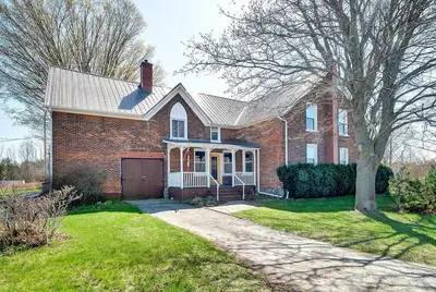 a brick house with a garage and a driveway at The Marigold PEC Family Farmhouse country escape in West Lake