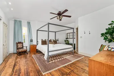 a bedroom with a canopy bed and a ceiling fan at The Marigold PEC Family Farmhouse country escape in West Lake