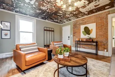 a living room with leather chairs and a table at From HGTV Marigold Suite in county farmhouse in West Lake