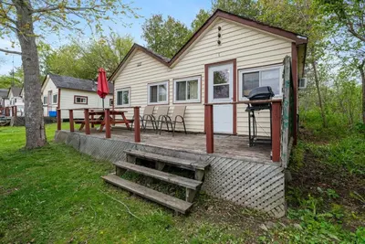 a tiny house with a grill and a table at Dive into Nature at Rice Lake in Bailieboro