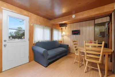 a living room with a blue couch and a table at Dive into Nature at Rice Lake in Bailieboro