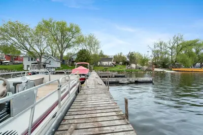 a boat is docked at a dock on a lake at Enjoy The Outdoors at Rice Lakes in Bailieboro