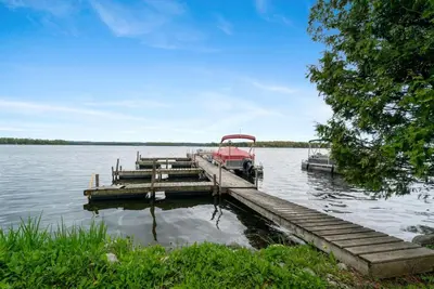 a boat is docked at a dock on a lake at Enjoy The Outdoors at Rice Lakes in Bailieboro