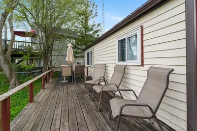 a wooden deck with chairs and an umbrella at Beautiful Lake Views in Nature in Bailieboro