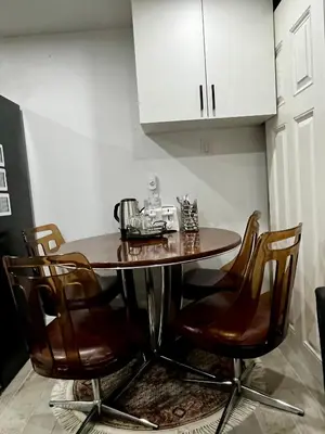 a kitchen with a wooden table and chairs at Brand new single unit guest basement apartment in Mississauga