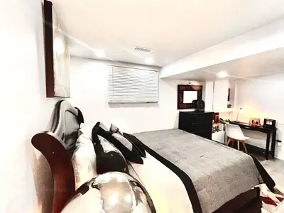 a bedroom with a bed and a desk at Brand new single unit guest basement apartment in Mississauga