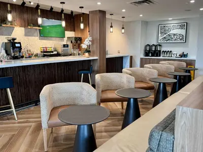 a restaurant with tables and chairs and a bar at Staybridge Suites St. Catharines Conf Ctr by IHG in St. Catharines