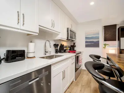 a kitchen with white cabinets and a counter top at Cozy Studio Apt - Corktown Hamilton - Near DT in Hamilton