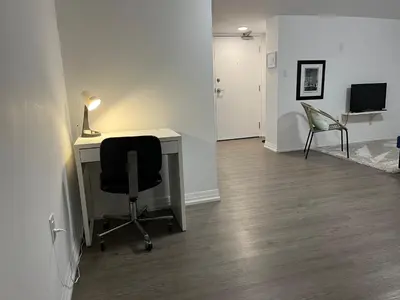 an office with a desk and a chair and a lamp at Merritt Place Niagara in St. Catharines