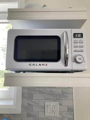 a microwave oven sitting on top of a counter at The Loft Retreat in Southampton