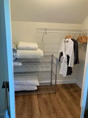 a laundry room with three drying racks and towels at The Loft Retreat in Southampton