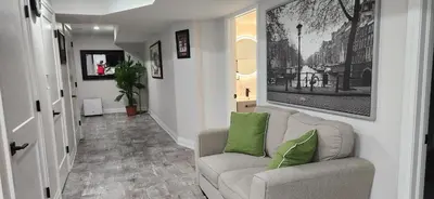 a living room with a couch and green pillows at Entire 2 Bedroom Apartment in Kitchener in Kitchener