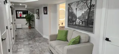 a living room with a couch and green pillows at Entire 2 Bedroom Apartment in Kitchener in Kitchener