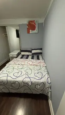 a bedroom with a bed with a bedspread with hearts on it at Bishop in Mississauga