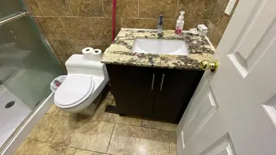 a bathroom with a white toilet and a sink at Bishop in Mississauga