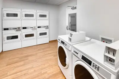 a laundry room with white appliances and cabinets at TownePlace Suites by Marriott Belleville in Belleville
