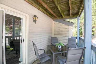 a patio with a table and chairs on a porch at Mountainside Retreat in Blue Mountains