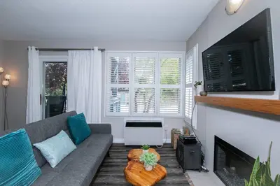 a living room with a couch and a fireplace at Mountainside Retreat in Blue Mountains