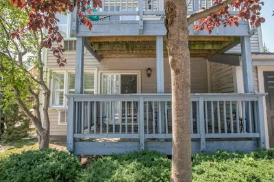 a house with a large porch with a deck at Mountainside Retreat in Blue Mountains