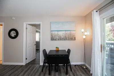 a dining room with a table and a painting on the wall at Mountainside Retreat in Blue Mountains