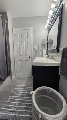 a bathroom with a toilet and a sink and a mirror at Home in Niagara region in St. Catharines
