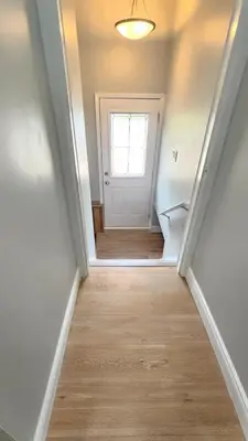 an empty hallway with a door and a window at Home in Niagara region in St. Catharines