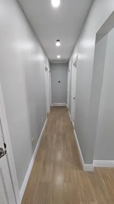 an empty hallway with white walls and wood floors at Home in Niagara region in St. Catharines