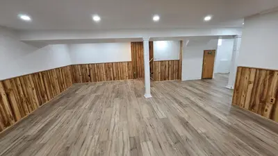 an empty room with wooden floors and walls at Home in Niagara region in St. Catharines