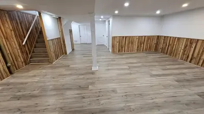 an empty room with wooden walls and a staircase at Home in Niagara region in St. Catharines