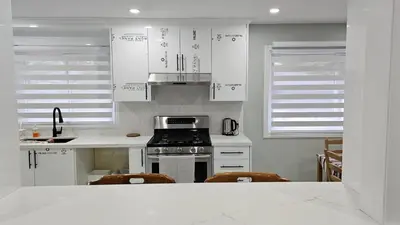 a kitchen with white cabinets and a stove top oven at Home in Niagara region in St. Catharines